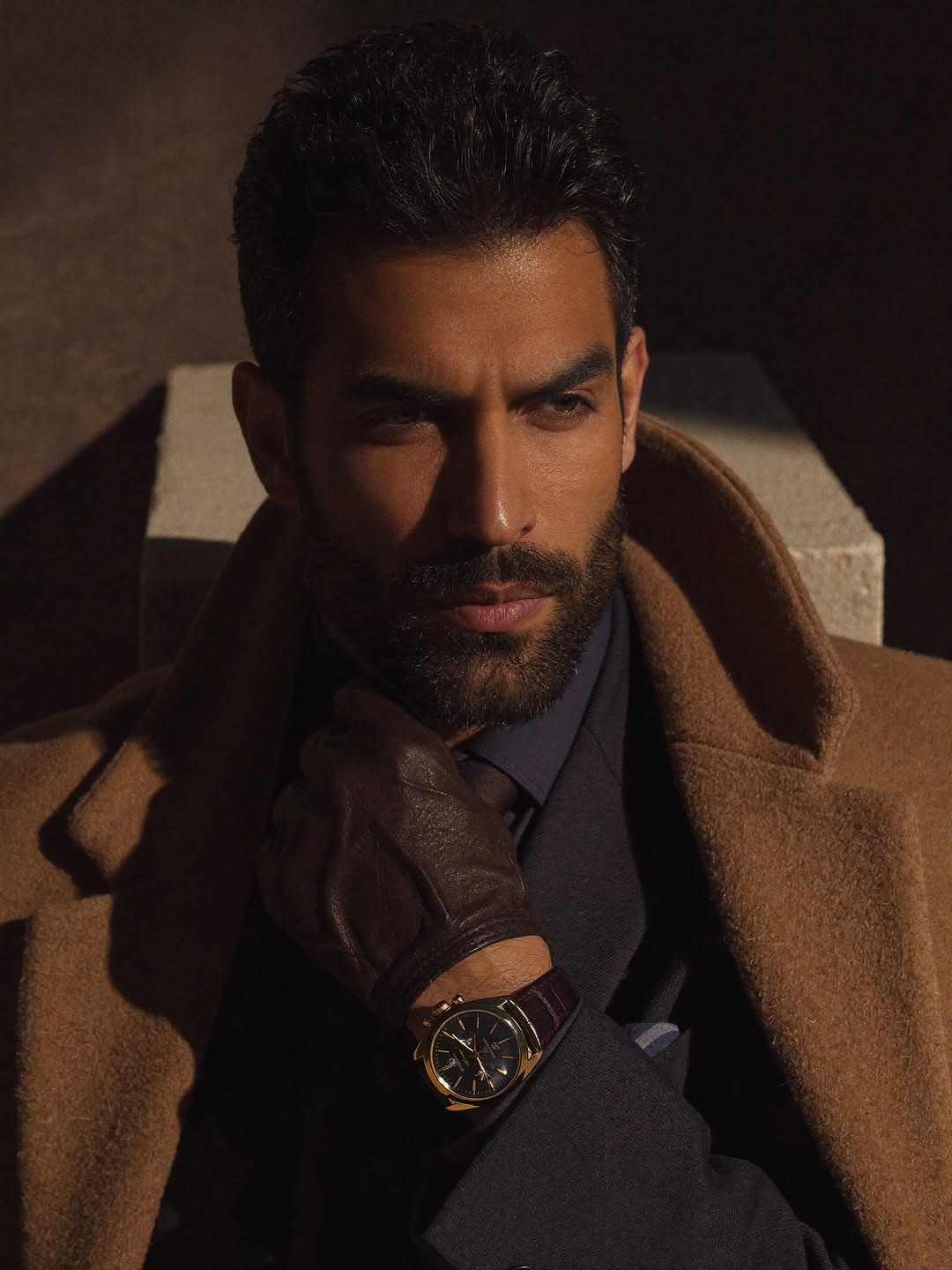 Saman Parham in a camel coat editorial portrait