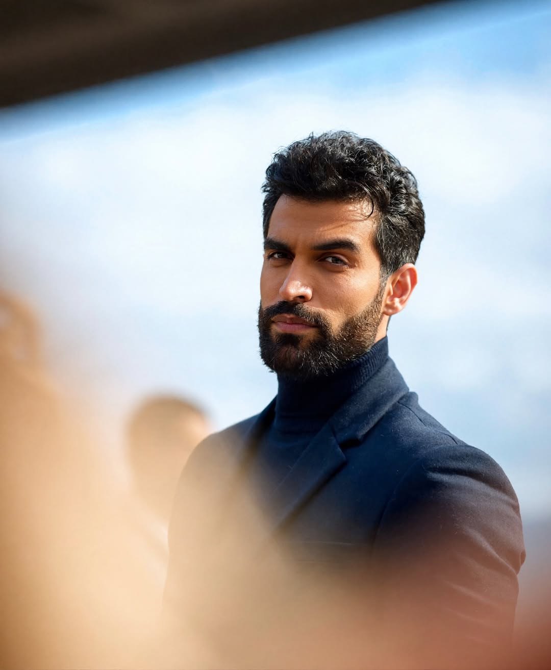 Saman Parham in a navy editorial portrait