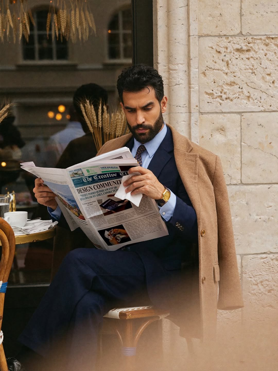 Saman Parham reading a newspaper in an editorial portrait